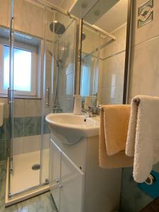 a bathroom with a sink and a shower at Apartment Kri-Mar in Selce +29 photos