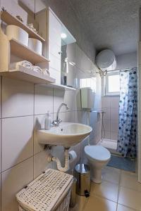 a bathroom with a sink and a toilet at The old Phone Center house in Ierápetra