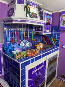 a toy kitchen with a blue tiled wall at Affitto Breve Short Rent Few hours in Catania