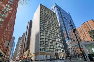 a tall building in the middle of a city at Nicely Equipped 1BR Apartment Close to Shops - Chestnut 22A in Chicago