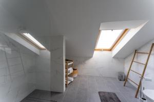 a attic bathroom with a skylight and a sink at Penthouse Formosa Sunset and Beach in Funchal +29 photos
