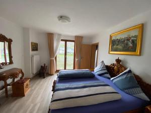 a bedroom with a large bed with blue sheets at Holiday Apartment mit Moselblick im Moselhaus in Cochem