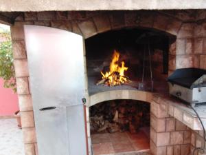 a brick oven with a fire in it at Studios Ravlić Marija in Makarska