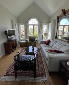 a living room with a couch and a table at Lulu's Bed & Breakfast in Niagara-on-the-Lake