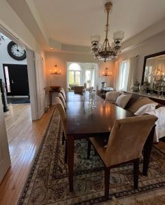 a dining room with a table and a couch at Lulu's Bed & Breakfast in Niagara-on-the-Lake