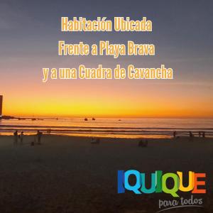 a picture of a beach at sunset with the words mitigation ukraine fracture at Habitación frente al mar in Iquique
