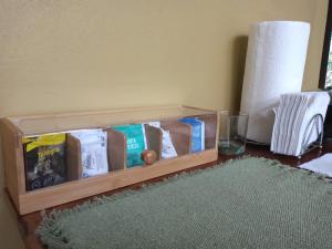 a wooden table with a box of food and a glass at Quality Cabins Monteverde in Monteverde Costa Rica