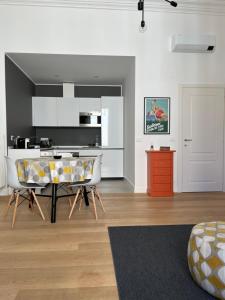 a kitchen with a table and chairs in a room at NONSOLOMARE wifi aria condizionata Parcheggio in Sanremo