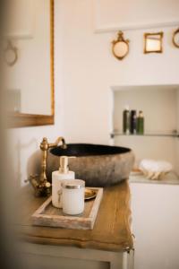 a bathroom with a stone sink on a wooden table at Elephant in my room in Dubrovnik +43 photos
