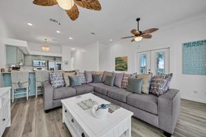 a living room with a couch and a table at Sand Castle Tower & Cabana in Panama City Beach