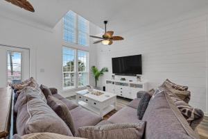 a living room with a couch and a flat screen tv at Sand Castle Tower & Cabana in Panama City Beach