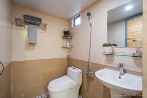 a bathroom with a toilet and a sink at Gỗ Thông Lâm Viên Villa Đà Lạt in Da Lat +43 photos