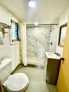 a bathroom with a toilet and a sink at Tropic Motel in Aransas Pass