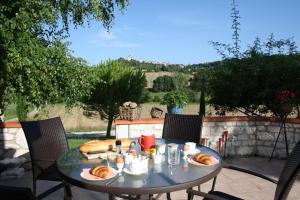 a table with food on it on a patio at La Perle du Lot in Castelnau-Montratier