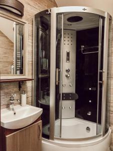 a bathroom with a shower and a sink at Apartament przy wyciągach,wieża widokowa in Krynica Zdrój