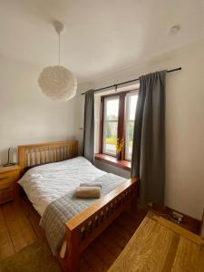 a bedroom with a bed and a window at 4B Millhill Street in Dunfermline