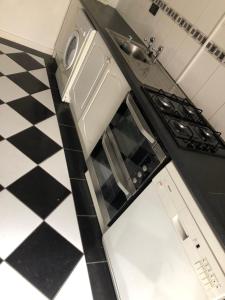 a kitchen with a sink and a stove at The Coach House Cottage, Bridge House Mews in Newbold