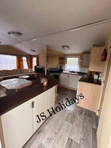 a kitchen and living room of an rv at JS Holidays The Westmorland Lagganhouse in Ballantrae
