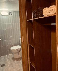 a bathroom with a toilet and a bathroom with a closet at Montana Inn in Wadi Musa +45 photos
