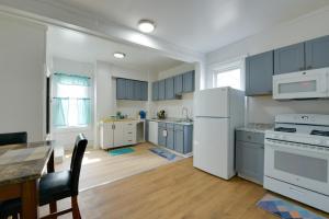 a kitchen with blue cabinets and a white refrigerator at Pet-Friendly Vacation Rental in Atlantic City! in Atlantic City