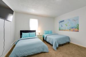 a bedroom with two beds and a painting on the wall at Pet-Friendly Vacation Rental in Atlantic City! in Atlantic City