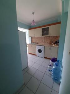 a kitchen with a washer and dryer in it at KESKINEL apart daire in Amasra