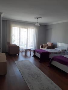 a living room with two beds and a couch at KESKINEL apart daire in Amasra