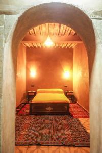 A bed or beds in a room at Riad Imuhar