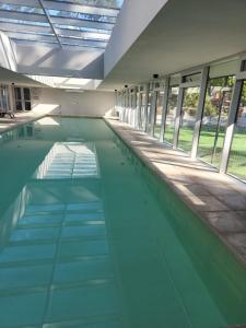 an empty swimming pool in a large building at Ocean Drive Country, Punta del Este - 2 amb de lujo in Punta del Este
