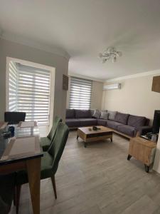 a living room with a couch and a table at Villa Maleyna in Kemer