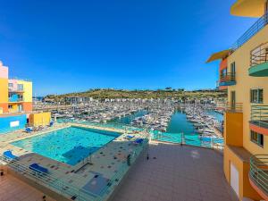 a large swimming pool with a marina with boats at Luxury 1 Bedroom Apartment, Marina de Albufeira3 in Albufeira