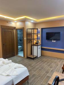 a room with a bed and a flat screen tv at CEMRE SUIT in Istanbul