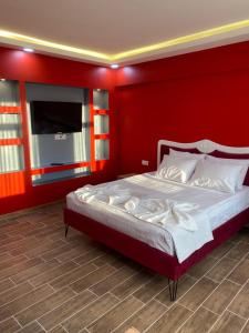 a red bedroom with a bed with a red wall at CEMRE SUIT in Istanbul