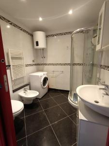a bathroom with two sinks and a shower and a toilet at Appartamenti Lungomare Savona in Savona