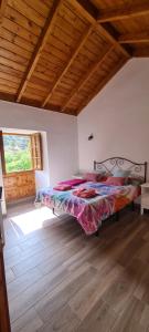 a bedroom with a bed in a room with a wooden ceiling at Casa Rural Antigua Escuela II in Hermigua