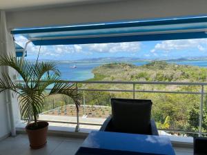 a living room with a view of the ocean at Résidence blue dream in Les Trois-Îlets