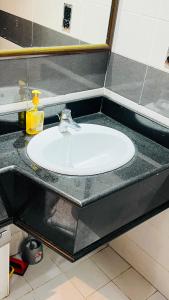 a white sink in a bathroom with a counter at Dubai Star Hostel in Dubai