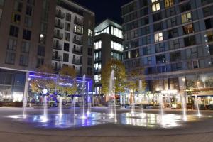 a fountain in the middle of a city at night at Stunning 2 bedroom apt in Milton Keynes