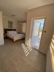 a bedroom with a bed and a sliding glass door at Villa Maleyna in Kemer +68 photos