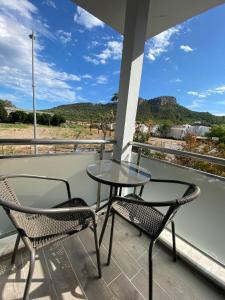 a patio with two chairs and a table on a balcony at Villa Maleyna in Kemer