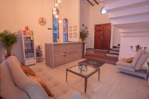 a living room with two couches and a coffee table at Aguacatala Hotel Boutique in Medellín