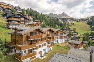 a group of houses on a hill in a village at Camelot 1 in Bettmeralp