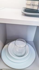 a glass bowl sitting on a plate on a shelf at Mimi's Private Compact and Cozy Ensuite in Netherton