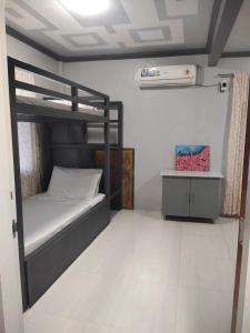 a bedroom with a bunk bed and a white floor at Rowena's River Resort 