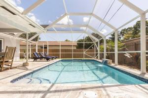 a swimming pool with a pergola and a swimming poolvisor at Garden View - Elite Staycation in Fort Lauderdale