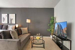 a living room with a couch and a flat screen tv at Sleek Studio Apartment in Gold Coast - Chestnut 19E in Chicago