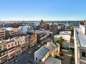 an aerial view of a city with buildings at 806/67 Arvia in Newcastle