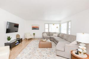 a living room with a couch and a tv at NEW Remodeled Townhome in Central Fargo in Fargo