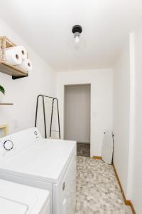 a white laundry room with a washer and dryer at NEW Remodeled Townhome in Central Fargo in Fargo
