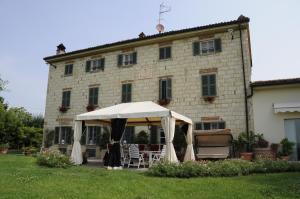 a white tent in front of a building at Cascina Manu in Rosignano Monferrato